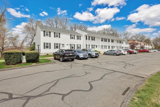 uncovered parking lot featuring a residential view