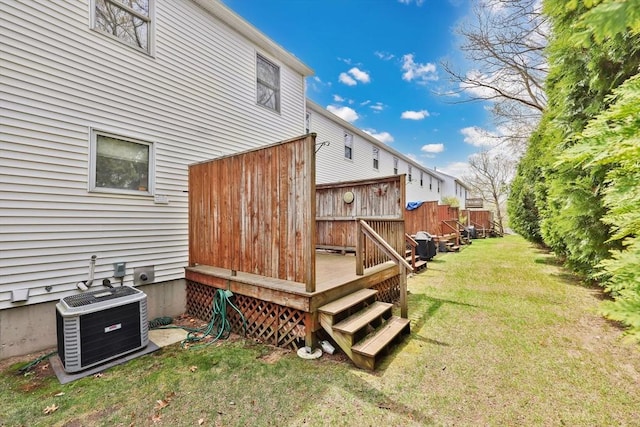 view of yard featuring central AC unit and a deck