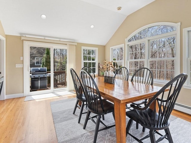 dining space featuring recessed lighting, light wood finished floors, vaulted ceiling, and baseboards