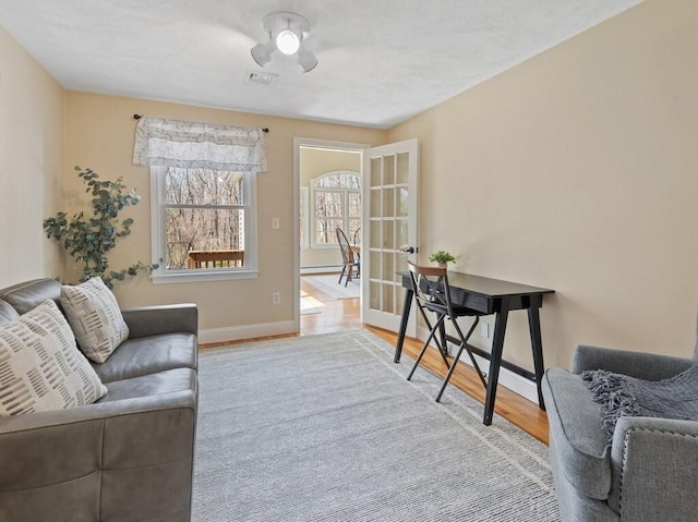 interior space with baseboards, visible vents, and wood finished floors