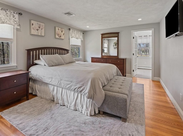 bedroom with recessed lighting, visible vents, wood finished floors, and multiple windows