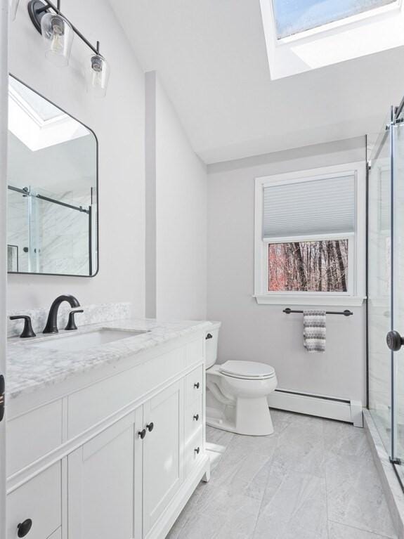 full bathroom with a baseboard radiator, marble finish floor, toilet, vanity, and a stall shower