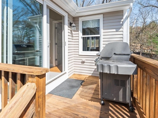 wooden terrace featuring a grill