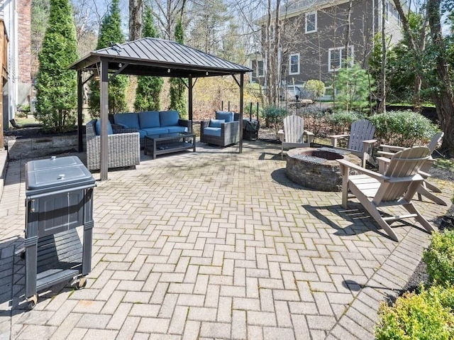 view of patio featuring an outdoor living space with a fire pit and a gazebo