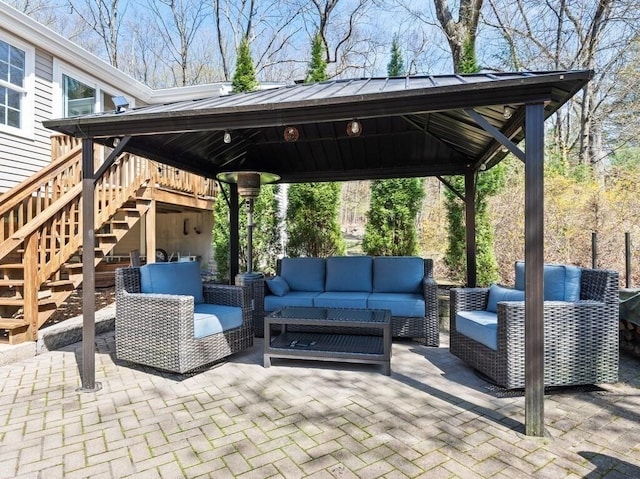 view of patio with an outdoor hangout area, a gazebo, and stairway