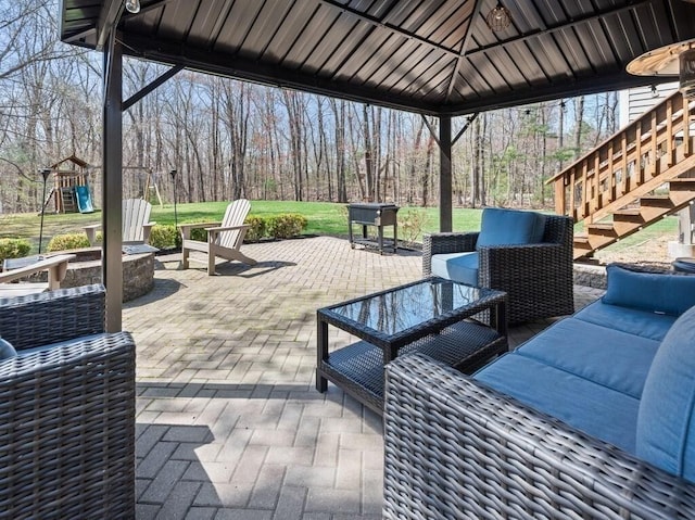 view of patio / terrace with an outdoor living space, a playground, and stairs