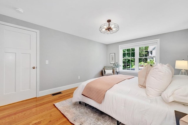5 Allen St Unit 5, Woburn, MA 01801 - bedroom featuring light wood-style flooring and a chandelier