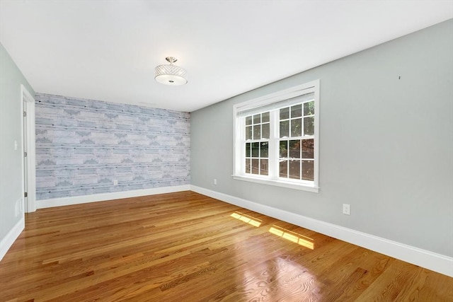 5 Allen St Unit 5, Woburn, MA 01801 - unfurnished room featuring an accent wall, wallpapered walls, and wood finished floors