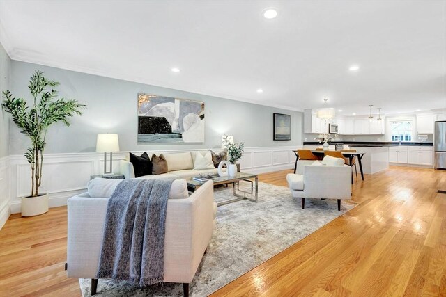 5 Allen St Unit 5, Woburn, MA 01801 - living area with crown molding, a decorative wall, light wood finished floors, recessed lighting, and a wainscoted wall