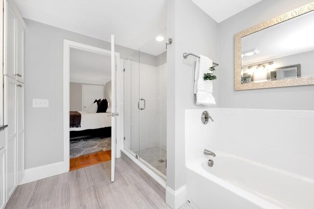 5 Allen St Unit 5, Woburn, MA 01801 - ensuite bathroom featuring a bath, a stall shower, and wood finished floors