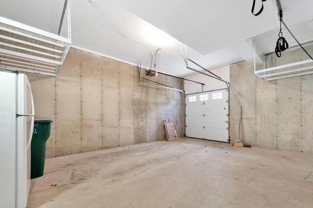 5 Allen St Unit 5, Woburn, MA 01801 - garage featuring freestanding refrigerator and a garage door opener