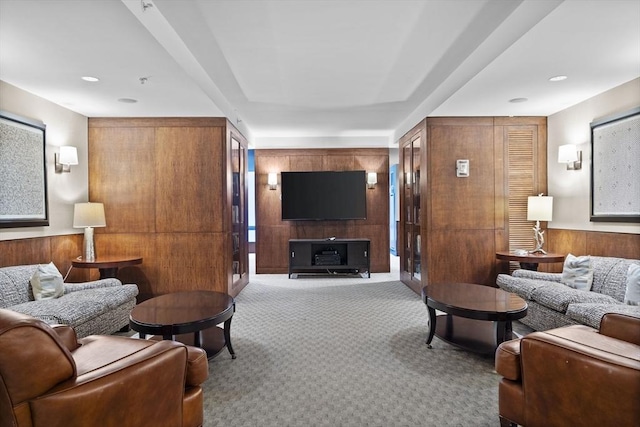 living room with wood walls and carpet floors