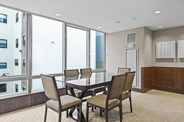 dining room featuring a healthy amount of sunlight and light colored carpet