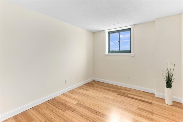 empty room with light hardwood / wood-style flooring