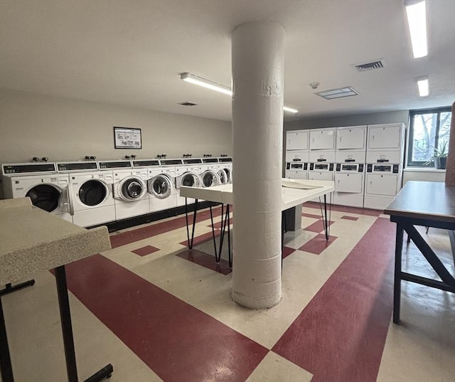 clothes washing area with stacked washer and clothes dryer