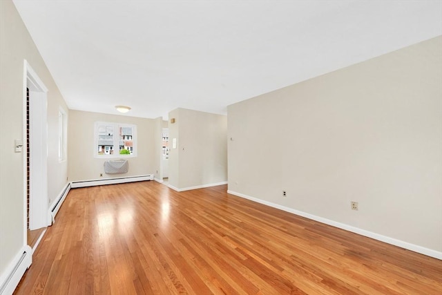 108 Emerson Gardens Rd Unit 108, Lexington, MA 02420 - spare room featuring a baseboard heating unit, light wood-style flooring, and baseboards