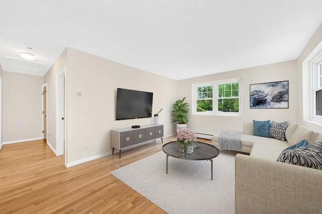 108 Emerson Gardens Rd Unit 108, Lexington, MA 02420 - living room featuring light wood-style floors, baseboards, and a baseboard heating unit