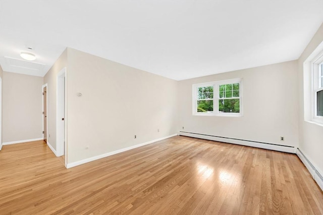 108 Emerson Gardens Rd Unit 108, Lexington, MA 02420 - unfurnished room featuring a baseboard heating unit, light wood finished floors, and baseboards