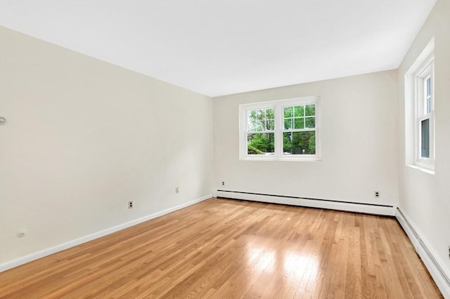 108 Emerson Gardens Rd Unit 108, Lexington, MA 02420 - unfurnished room with light wood-style flooring, baseboard heating, and baseboards