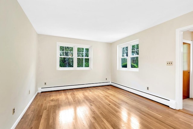 108 Emerson Gardens Rd Unit 108, Lexington, MA 02420 - unfurnished room with healthy amount of natural light, baseboard heating, wood finished floors, and a baseboard radiator