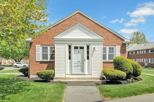 108 Emerson Gardens Rd Unit 108, Lexington, MA 02420 - view of front of house featuring brick siding and a front yard