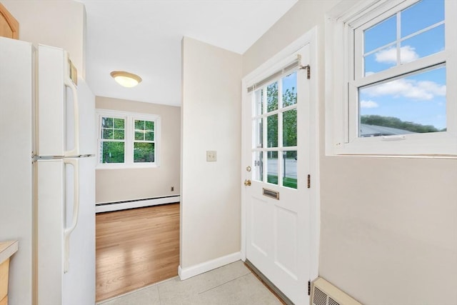 108 Emerson Gardens Rd Unit 108, Lexington, MA 02420 - doorway to outside with a baseboard radiator and baseboards