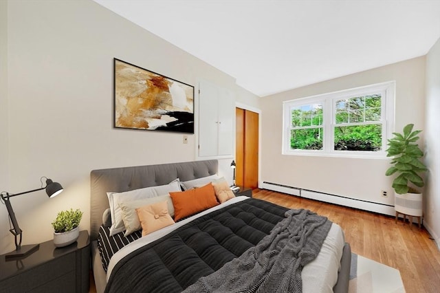 108 Emerson Gardens Rd Unit 108, Lexington, MA 02420 - bedroom with a baseboard radiator and light wood-style floors