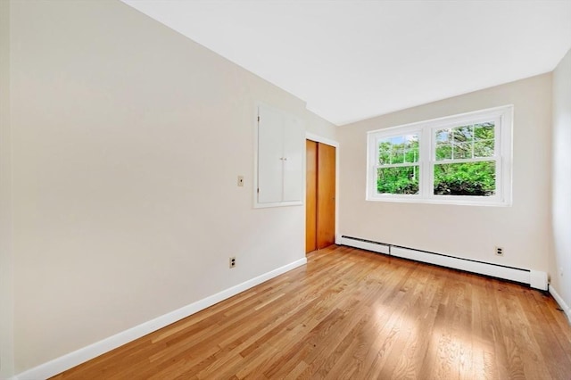 108 Emerson Gardens Rd Unit 108, Lexington, MA 02420 - empty room featuring baseboard heating, baseboards, light wood-style flooring, and electric panel