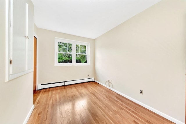 108 Emerson Gardens Rd Unit 108, Lexington, MA 02420 - unfurnished bedroom featuring a baseboard radiator, wood finished floors, and baseboards