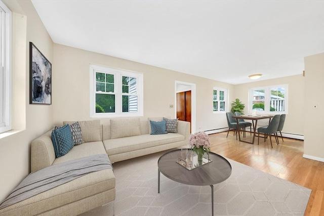 108 Emerson Gardens Rd Unit 108, Lexington, MA 02420 - living room featuring light wood-style floors, healthy amount of natural light, and a baseboard radiator