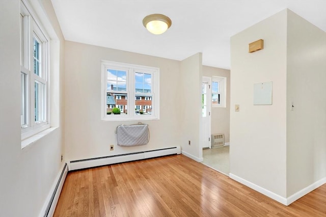 108 Emerson Gardens Rd Unit 108, Lexington, MA 02420 - empty room with light wood-style floors, a baseboard heating unit, and baseboards