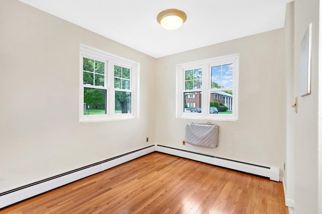 108 Emerson Gardens Rd Unit 108, Lexington, MA 02420 - empty room with light wood finished floors and a baseboard radiator