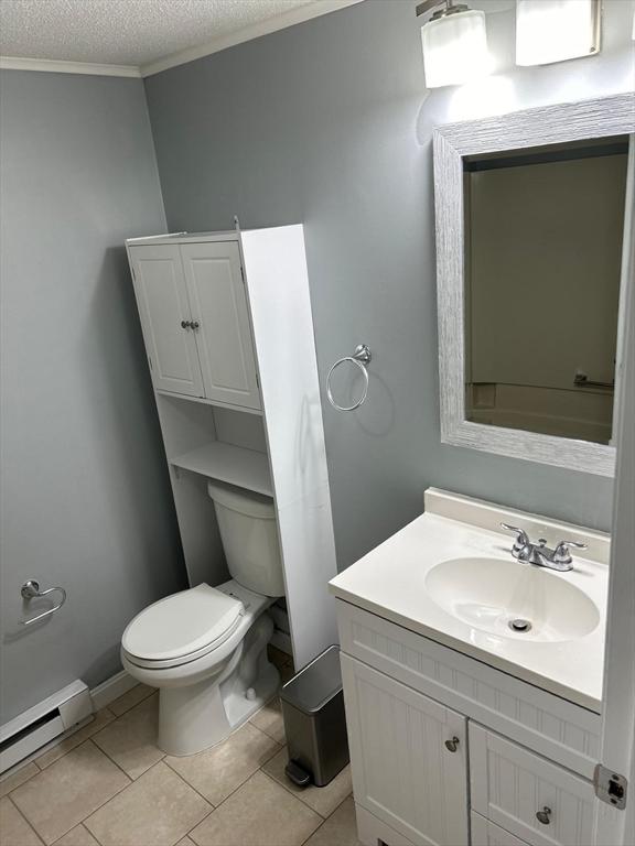 450-458 Riverside Dr Unit 2, Lawrence, MA 01841 - bathroom with a baseboard radiator, vanity, a textured ceiling, tile patterned flooring, and crown molding