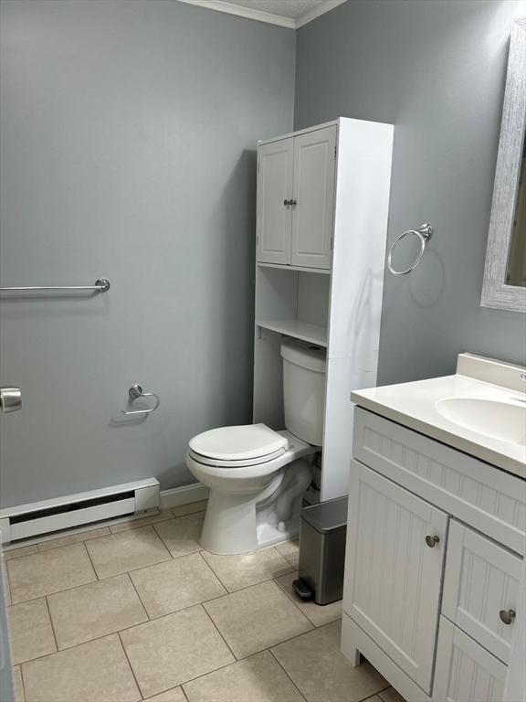 450-458 Riverside Dr Unit 2, Lawrence, MA 01841 - bathroom featuring a baseboard heating unit, ornamental molding, vanity, and tile patterned floors