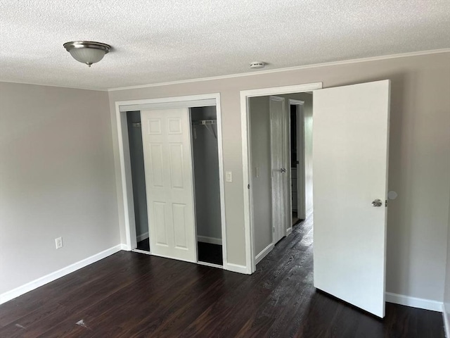 450-458 Riverside Dr Unit 2, Lawrence, MA 01841 - unfurnished bedroom featuring a textured ceiling, dark wood-style floors, a closet, and ornamental molding