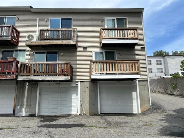 450-458 Riverside Dr Unit 2, Lawrence, MA 01841 - rear view of house featuring an attached garage, a balcony, and driveway