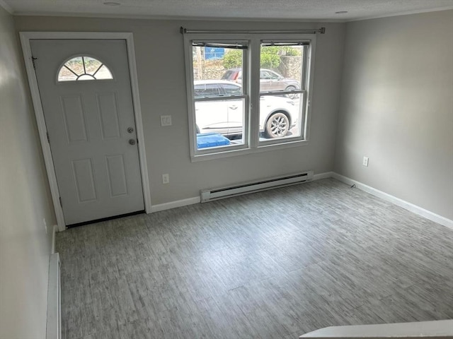 450-458 Riverside Dr Unit 2, Lawrence, MA 01841 - foyer with a baseboard radiator, wood finished floors, plenty of natural light, and a textured ceiling