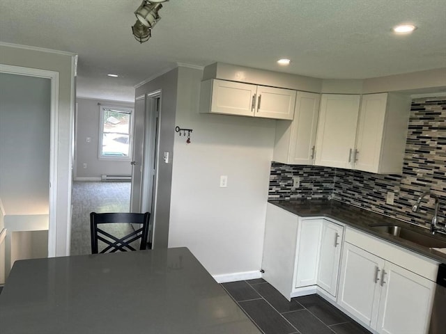 450-458 Riverside Dr Unit 2, Lawrence, MA 01841 - kitchen with dark countertops, white cabinetry, decorative backsplash, recessed lighting, and a baseboard heating unit