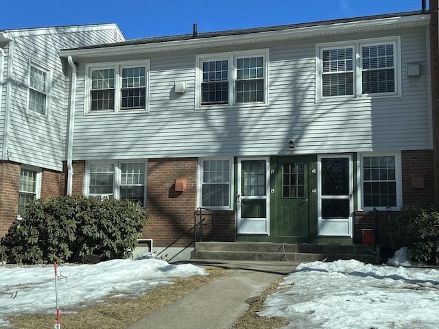 view of front of house featuring entry steps and brick siding