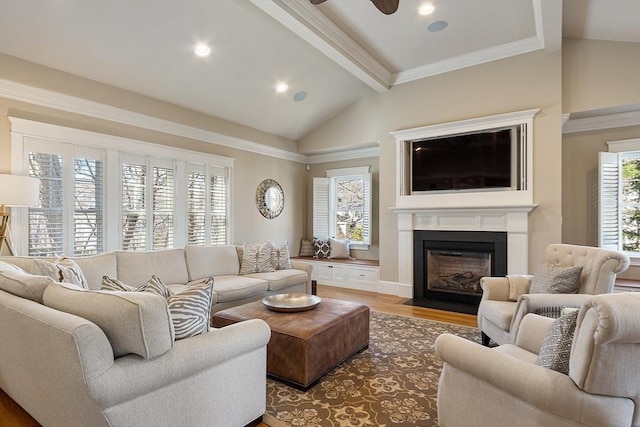 living room featuring lofted ceiling with beams, a fireplace with flush hearth, recessed lighting, ornamental molding, and light wood-style floors