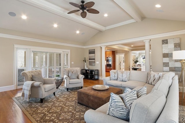 living room featuring a ceiling fan, wood finished floors, baseboards, lofted ceiling with beams, and decorative columns