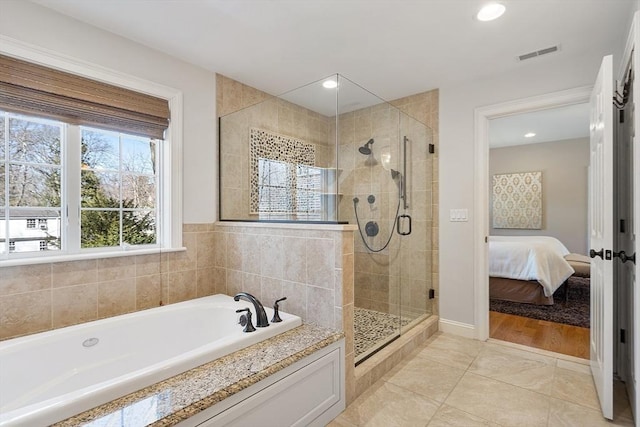 ensuite bathroom featuring visible vents, a stall shower, ensuite bath, tile patterned flooring, and a bath