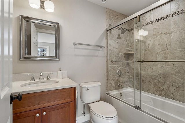 full bath featuring combined bath / shower with glass door, toilet, and vanity