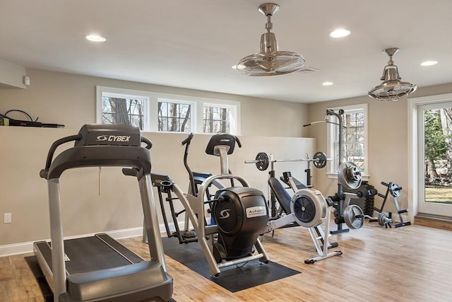 exercise room featuring recessed lighting, baseboards, and wood finished floors