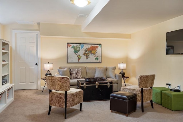 living area with light colored carpet and visible vents