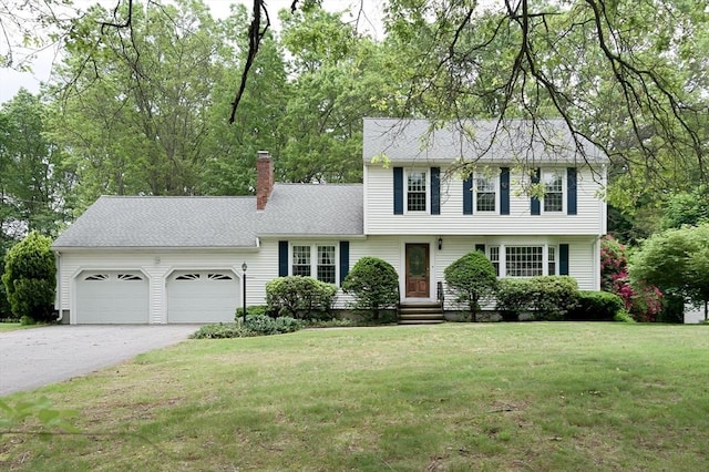 40 Langley Ln, Tewksbury, MA 01876 - colonial inspired home with an attached garage, a chimney, concrete driveway, and a front yard