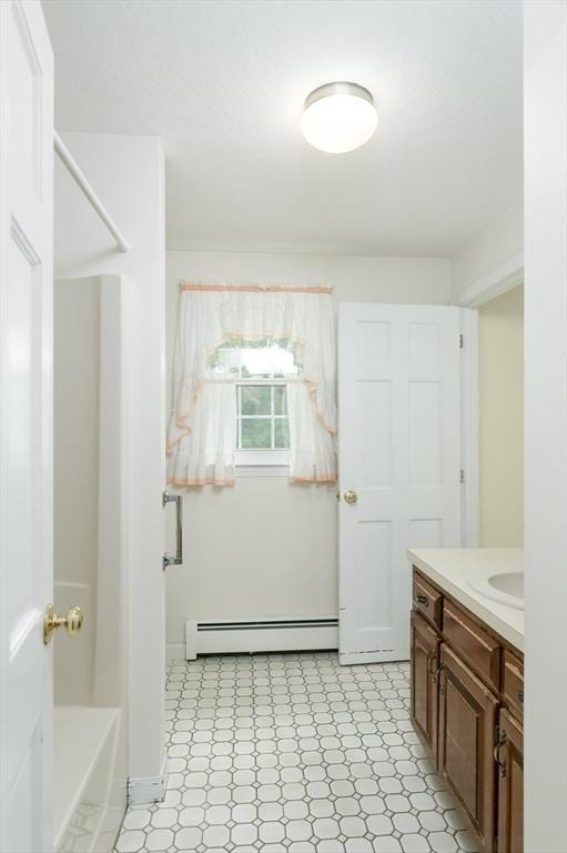 40 Langley Ln, Tewksbury, MA 01876 - full bath with baseboard heating, vanity, tile patterned floors, a shower, and a tub to relax in
