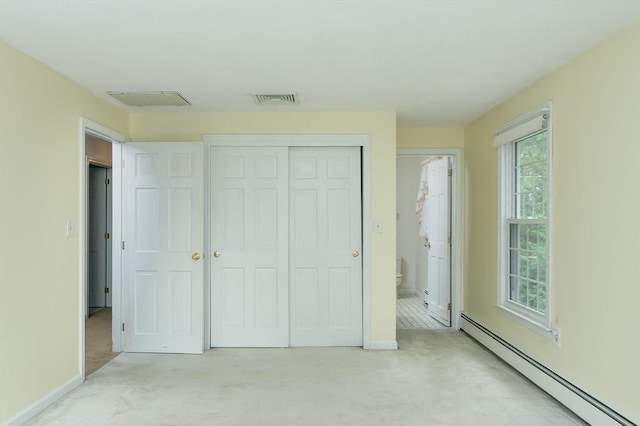 40 Langley Ln, Tewksbury, MA 01876 - unfurnished bedroom with a baseboard heating unit, a closet, light carpet, and baseboards