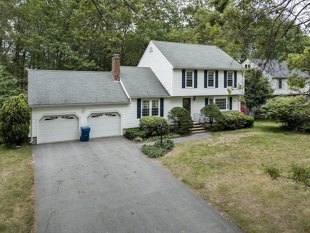 40 Langley Ln, Tewksbury, MA 01876 - colonial house with a garage, asphalt driveway, a chimney, a front lawn, and roof with shingles