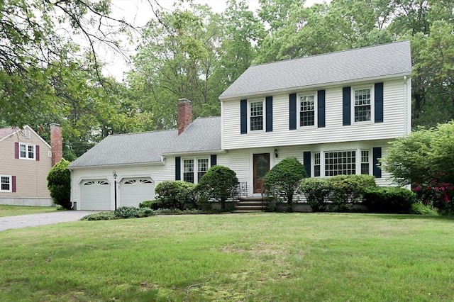 40 Langley Ln, Tewksbury, MA 01876 - colonial inspired home featuring a garage, driveway, a front yard, a chimney, and roof with shingles